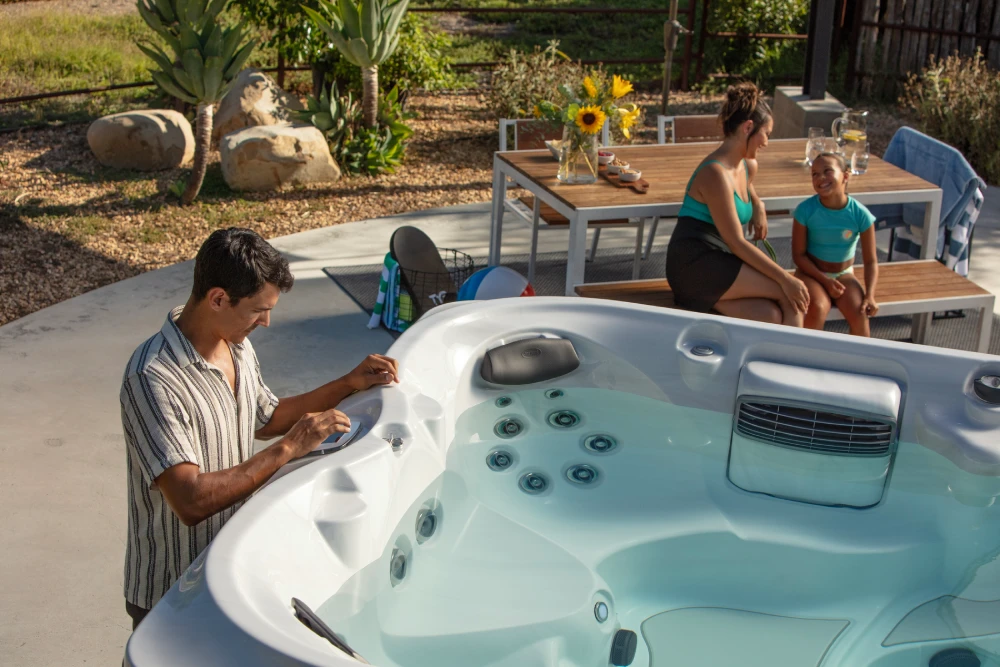 Man setting temperature on a jacuzzi swim spa