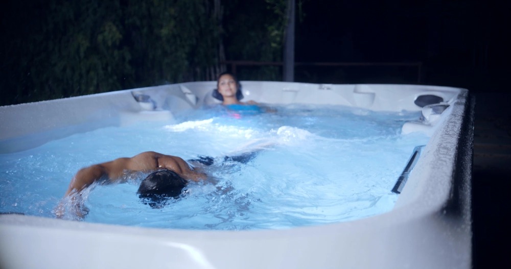 j16 powerpro couple in their jacuzzi swim spa